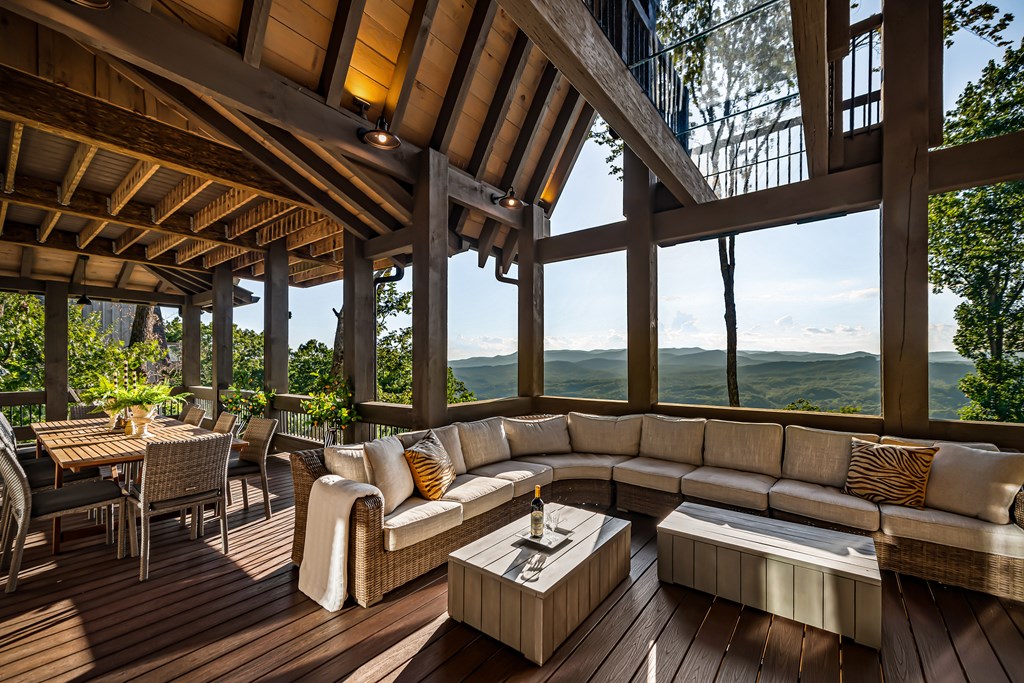 520 Overlook Drive Blue Ridge, GA 30513 - Photo 10 of 84 a living room with furniture and a floor to ceiling window next to a large tree