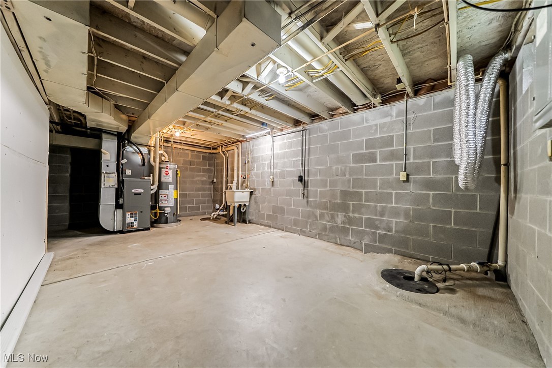 761 Garfield Street Akron, OH 44310 - Photo 25 of 31 Unfinished basement featuring heating unit and water heater