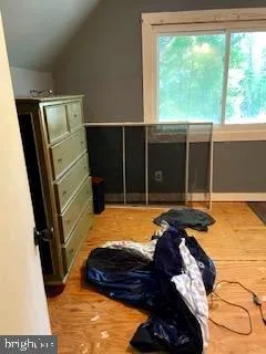 a view of a room with wooden floor and a window