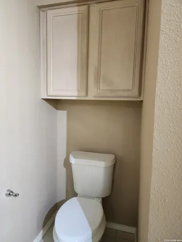 a white toilet sitting next to a bathroom sink
