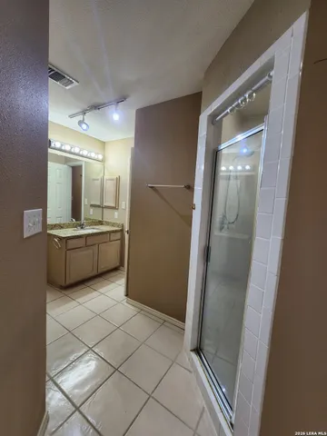 a bathroom with a sink a mirror and a shower