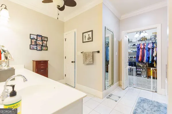 a view of walk in closet with clothes
