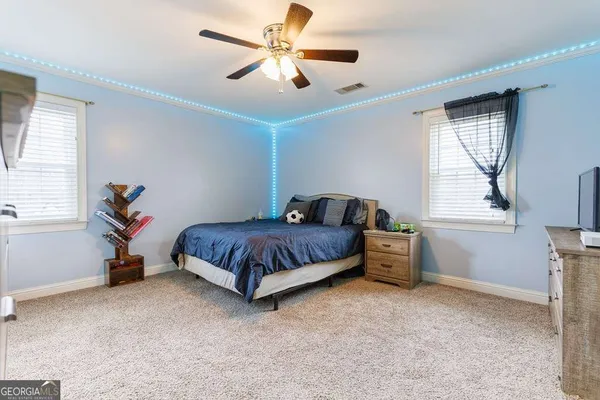 a living room with a bed furniture and a window