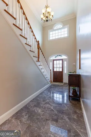 a living room with fireplace furniture and a chandelier
