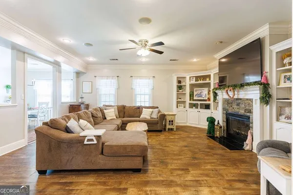 a kitchen with stainless steel appliances a dining table chairs stove and refrigerator