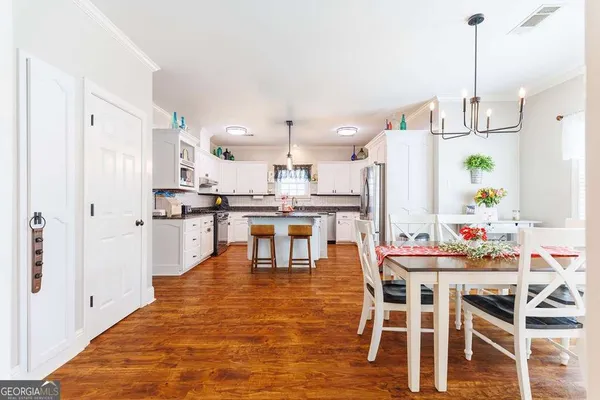 a kitchen with granite countertop white cabinets and white appliances