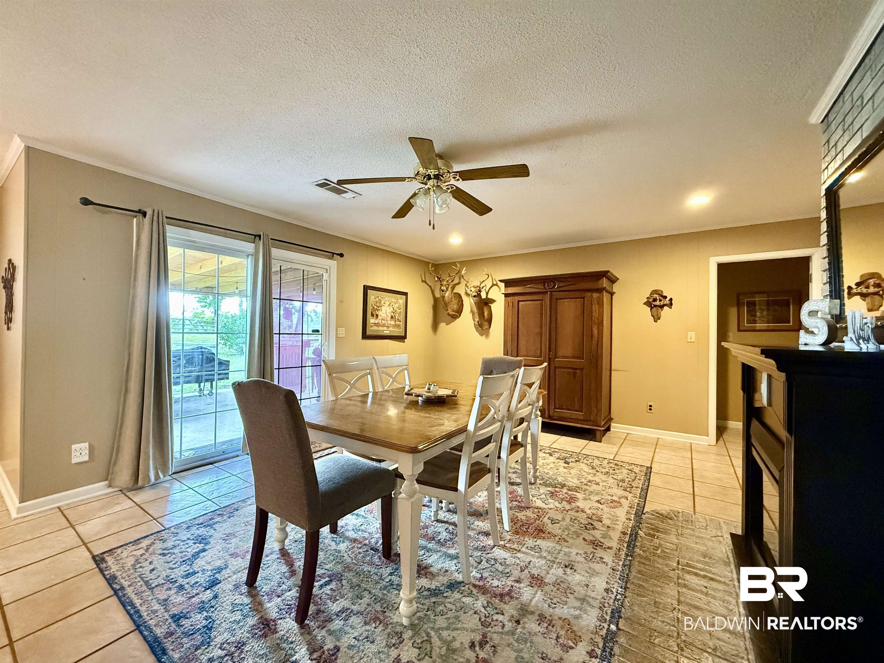 5971 Appleton Road Brewton, AL 36426 - Photo 6 of 23 Dining room featuring light tile patterned flooring, a textured ceiling, and a ceiling fan