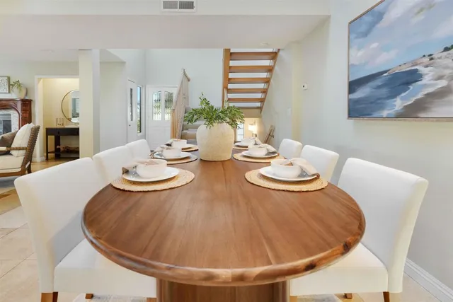 a living room with furniture and a dining table