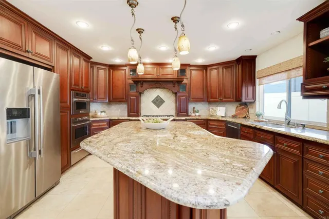 a bathroom with granite countertop a sink and a wooden floor