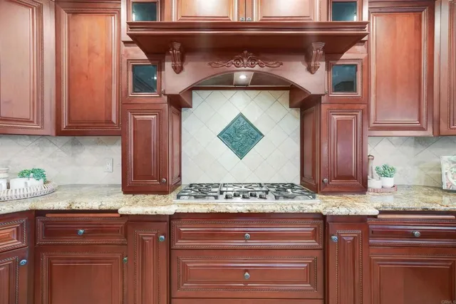 a kitchen with granite countertop stainless steel appliances wooden cabinet and a granite counter tops