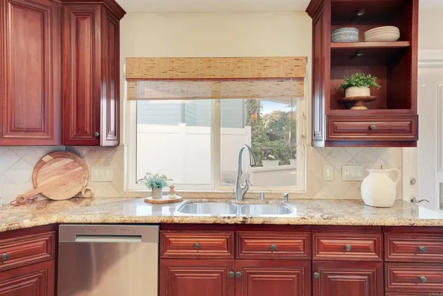 a large kitchen with granite countertop a sink and a stove