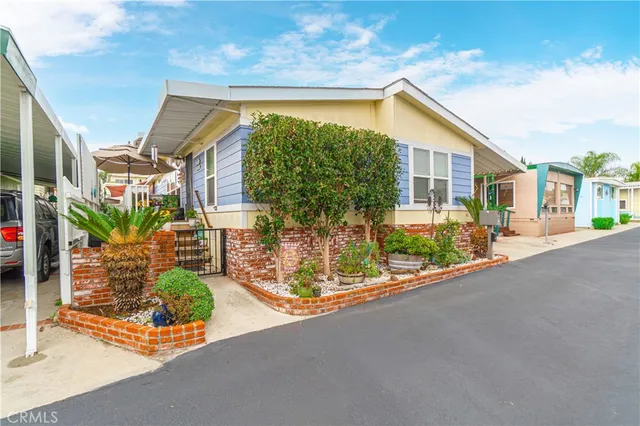 a view of a street with potted plants