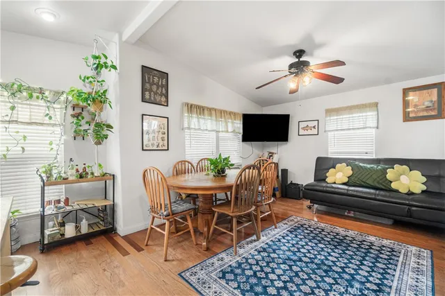 a living room with furniture a flat screen tv and a potted plant