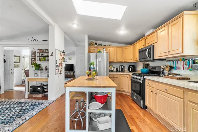 a kitchen with stainless steel appliances granite countertop a sink and cabinets