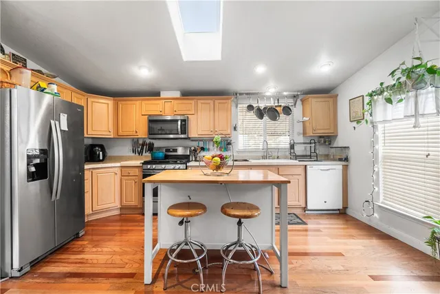 a kitchen with refrigerator cabinets dining table and chairs