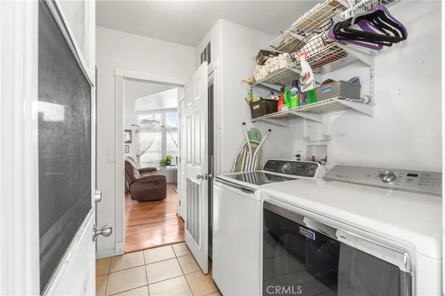a utility room with sink dryer and washer