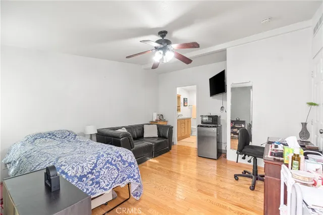 a spacious bedroom with a bed a couch and dresser