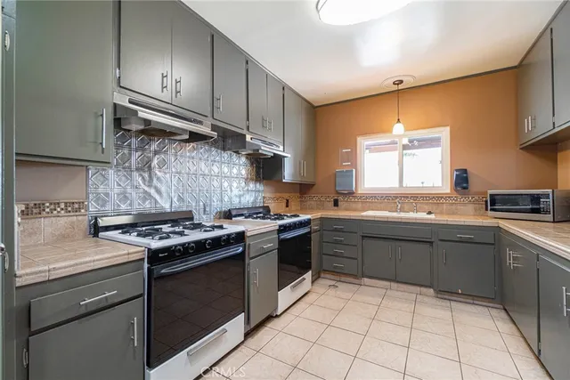 a room with pool table and windows