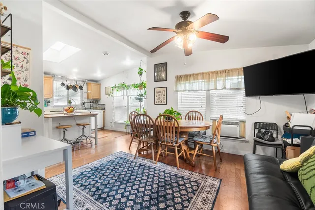 a living room with furniture a rug and a flat screen tv