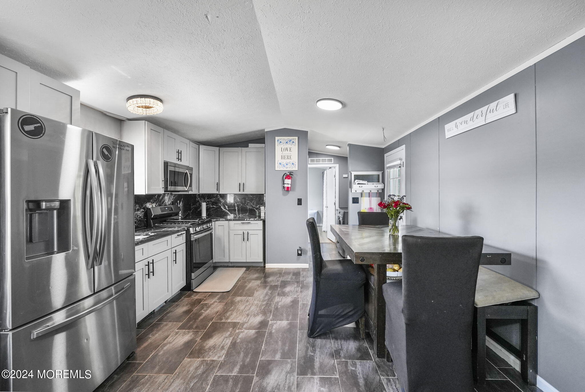 813 North Street Jackson, NJ 08527 - Photo 2 of 19 a kitchen with stainless steel appliances a refrigerator stove microwave and cabinets