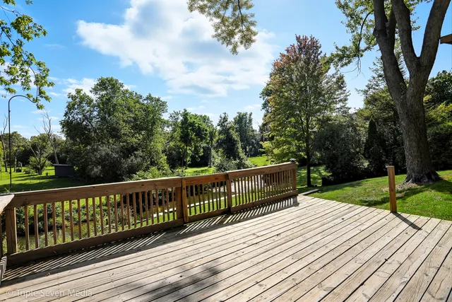 a view of wooden deck and a garden
