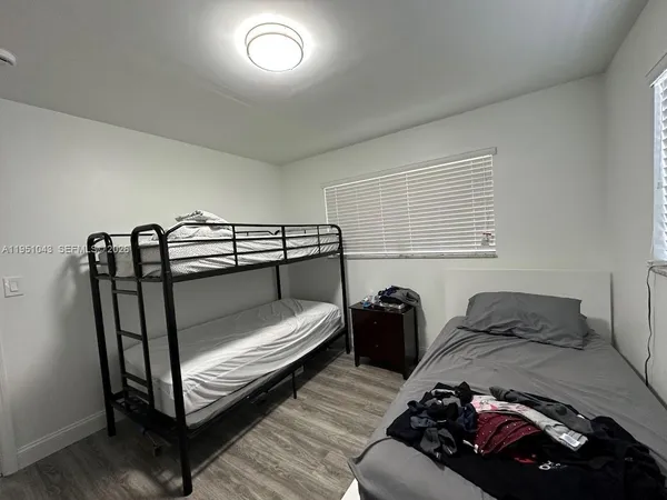 a bedroom with double bed and a window