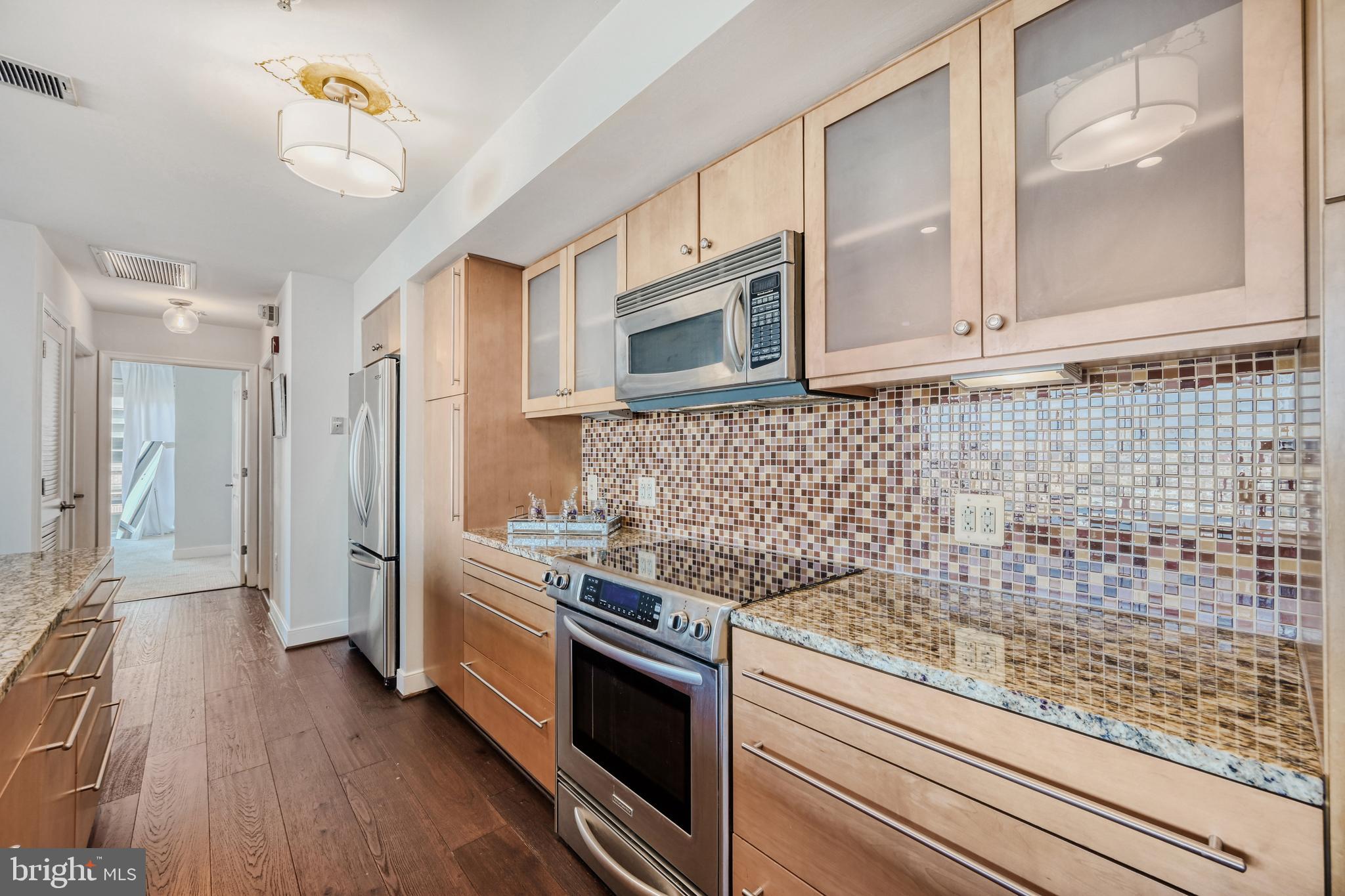 675 President Street, Unit 1406 Baltimore, MD 21202 - Photo 12 of 46 a kitchen with a stove oven and cabinets