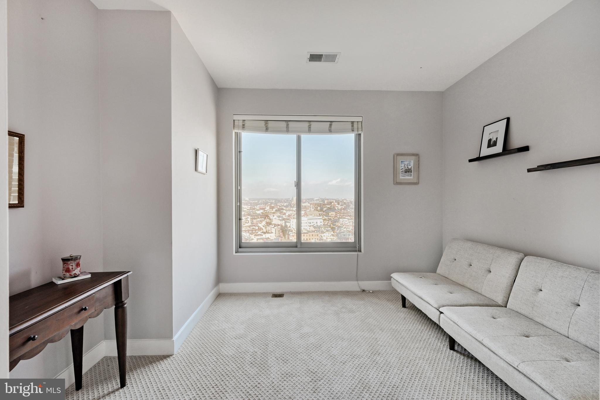 675 President Street, Unit 1406 Baltimore, MD 21202 - Photo 17 of 46 a living room with furniture and a window