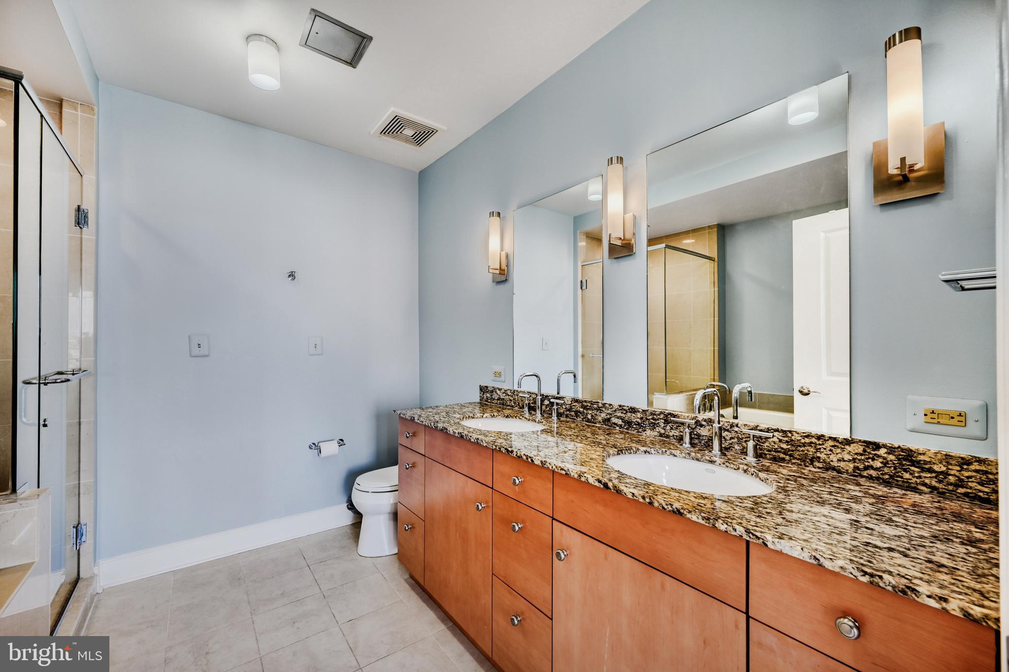 675 President Street, Unit 1406 Baltimore, MD 21202 - Photo 23 of 46 a bathroom with a sink double vanity and a mirror