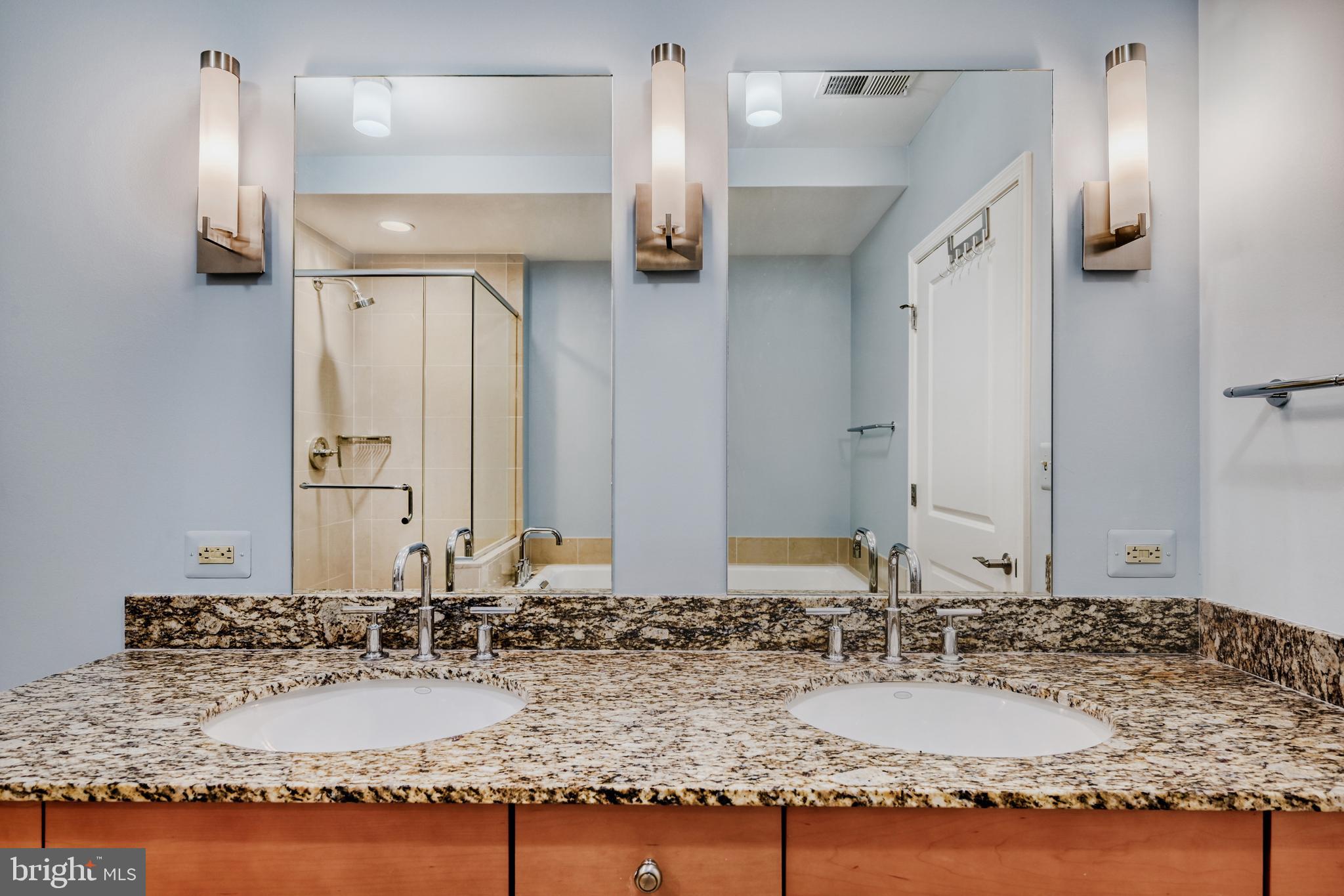675 President Street, Unit 1406 Baltimore, MD 21202 - Photo 24 of 46 a bathroom with a granite countertop sink and a mirror