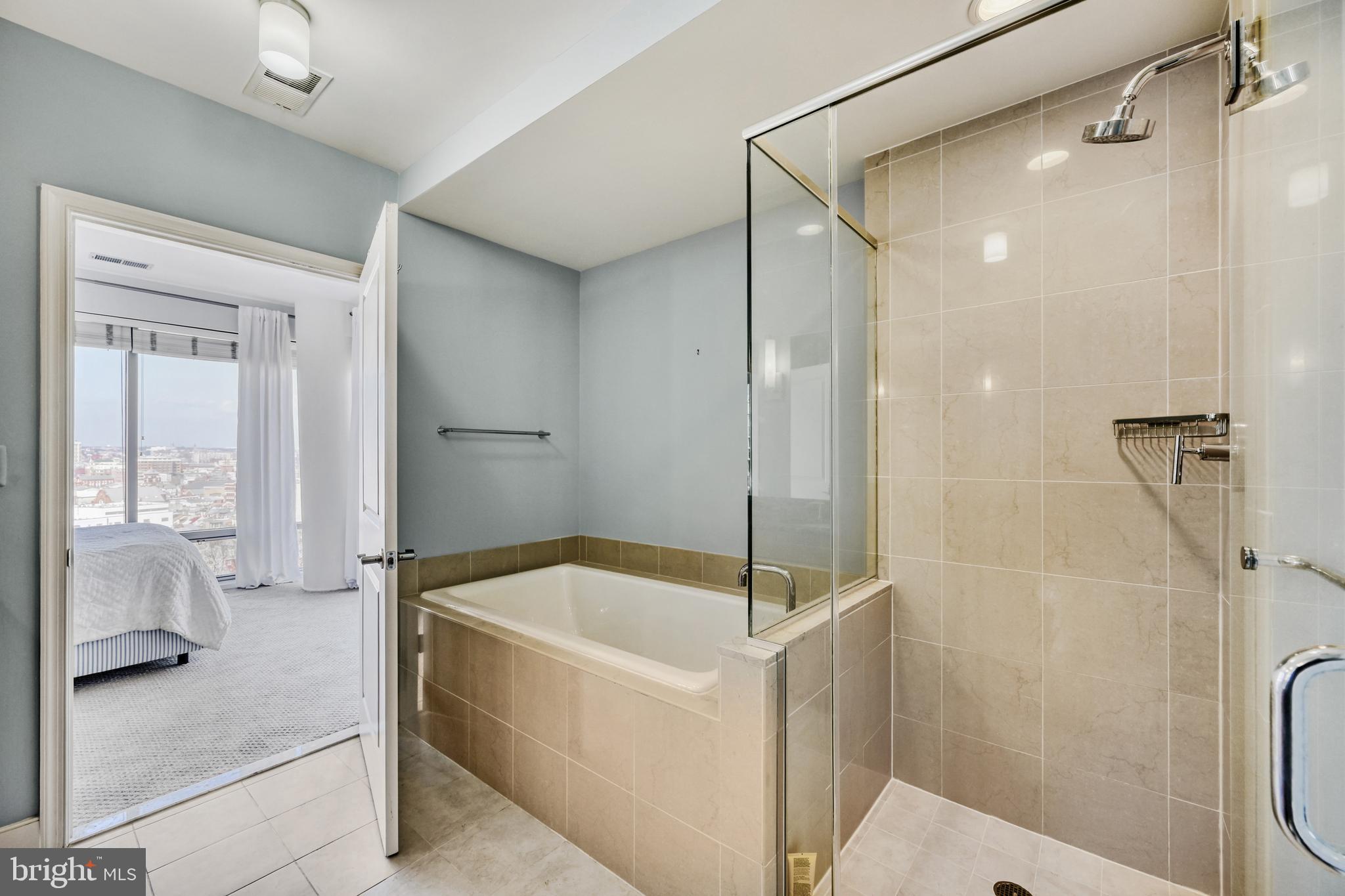 675 President Street, Unit 1406 Baltimore, MD 21202 - Photo 25 of 46 a bathroom with a tub and a shower