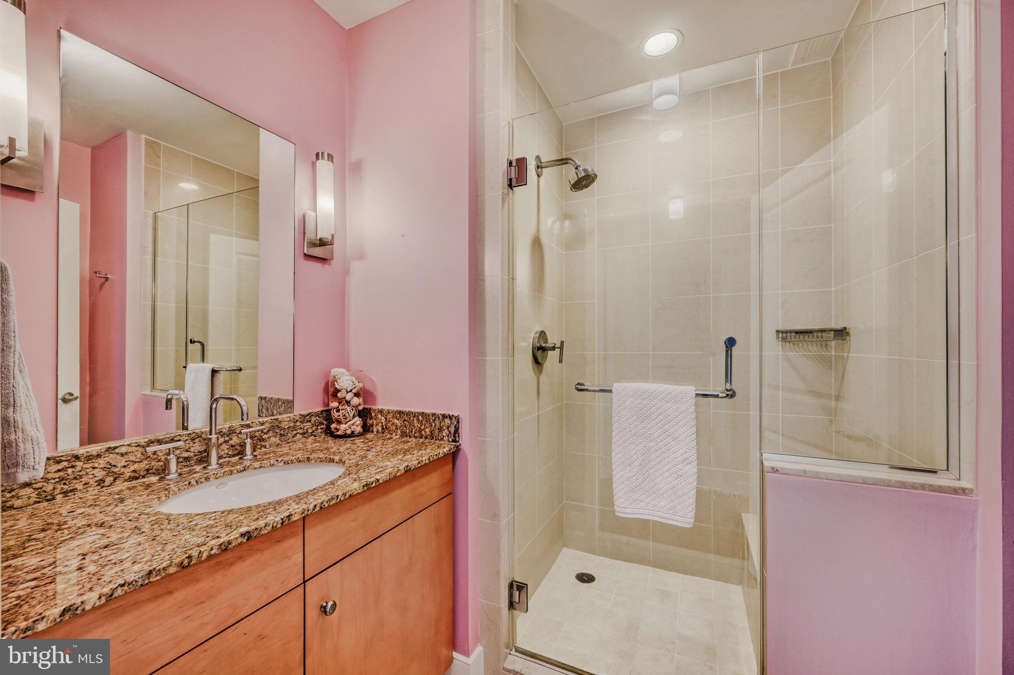 675 President Street, Unit 1406 Baltimore, MD 21202 - Photo 28 of 46 a bathroom with a granite countertop sink mirror and double