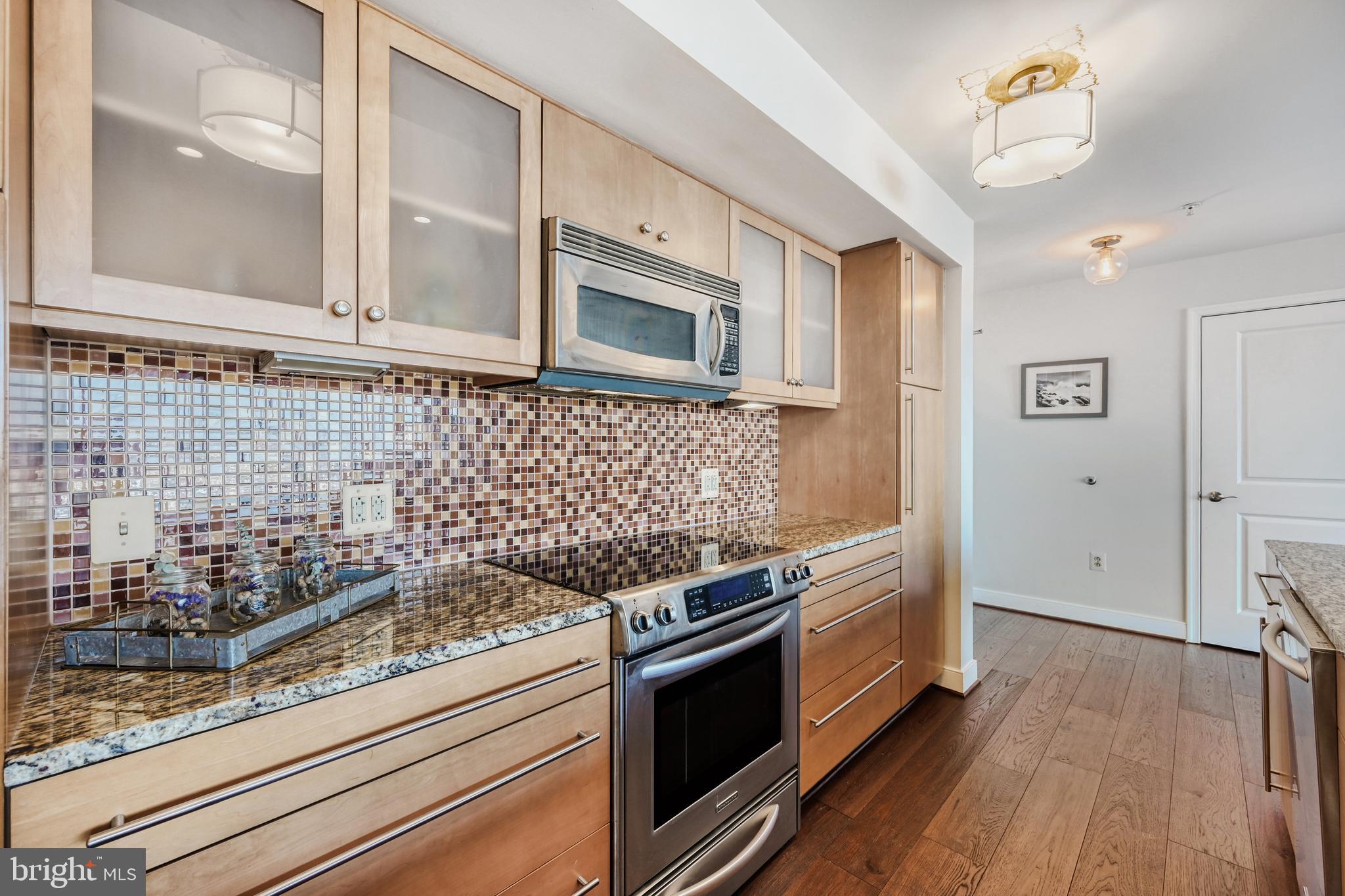675 President Street, Unit 1406 Baltimore, MD 21202 - Photo 9 of 46 a kitchen with stainless steel appliances granite countertop a stove and a refrigerator