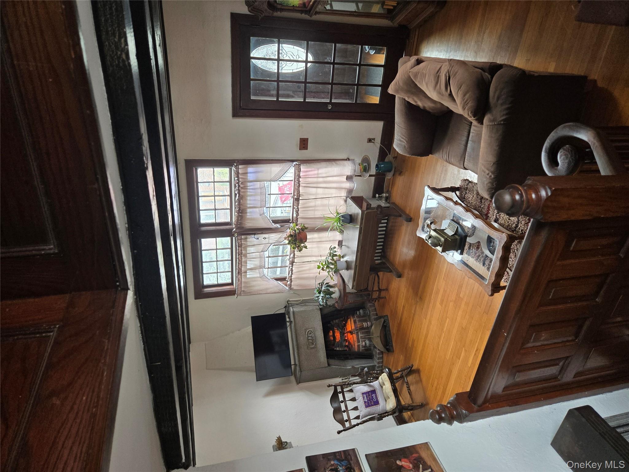 89-12 Rutledge Avenue Queens, NY 11385 - Photo 7 of 13 a living room with furniture and a flat screen tv
