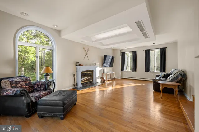 a living room with furniture fireplace and a large window