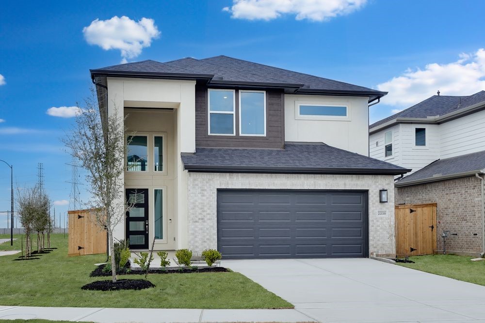 a front view of a house with a yard and garage