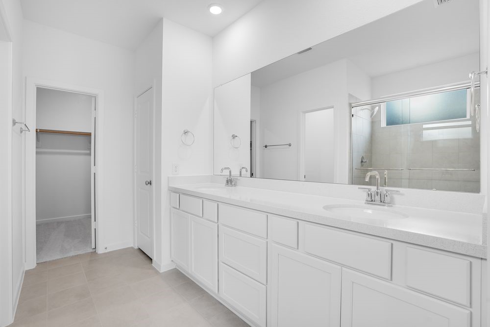 22130 Rangemore Drive Cypress, TX 77433 - Photo 14 of 36 a bathroom with double sink and a mirror