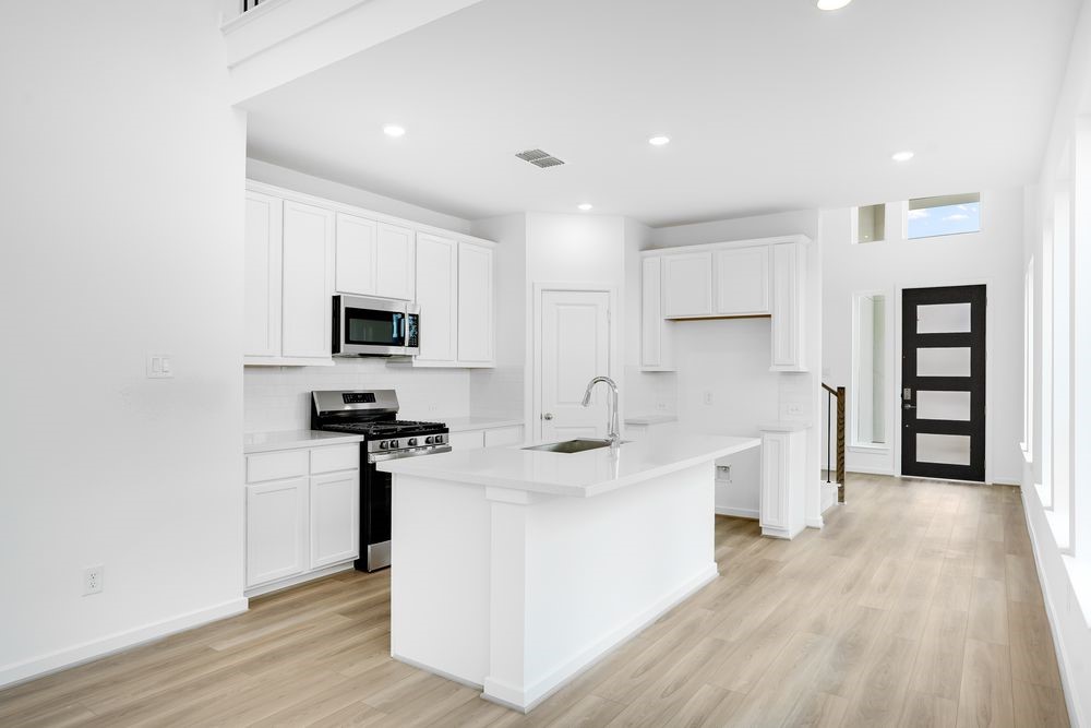 22130 Rangemore Drive Cypress, TX 77433 - Photo 2 of 36 a kitchen with stainless steel appliances a sink stove and cabinets