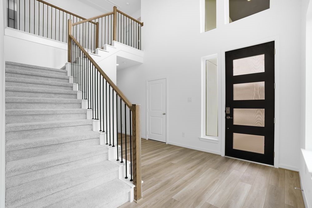 22130 Rangemore Drive Cypress, TX 77433 - Photo 21 of 36 a view of staircase with wooden floor and white walls