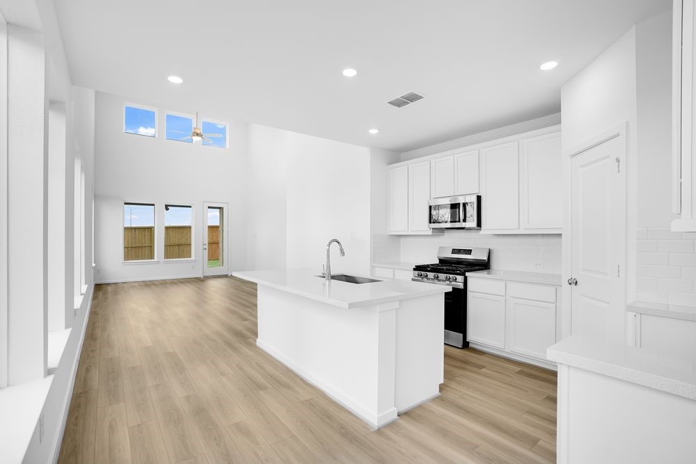 22130 Rangemore Drive Cypress, TX 77433 - Photo 4 of 36 a kitchen with stainless steel appliances granite countertop a stove and a refrigerator