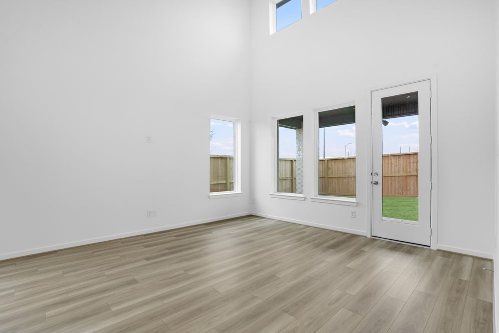 22130 Rangemore Drive Cypress, TX 77433 - Photo 5 of 36 an empty room with wooden floor and windows