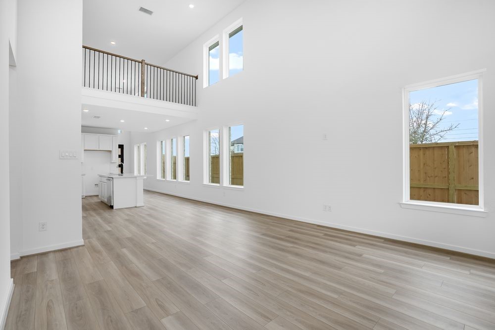 22130 Rangemore Drive Cypress, TX 77433 - Photo 7 of 36 a view of an empty room with wooden floor and a window