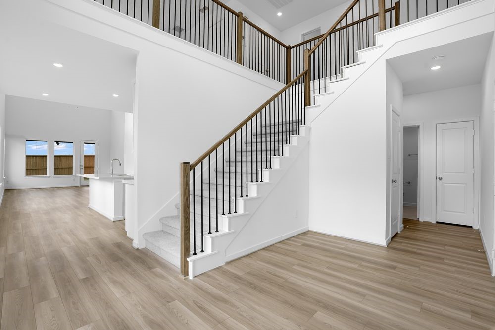 22130 Rangemore Drive Cypress, TX 77433 - Photo 10 of 36 a view of staircase with wooden floor and white walls