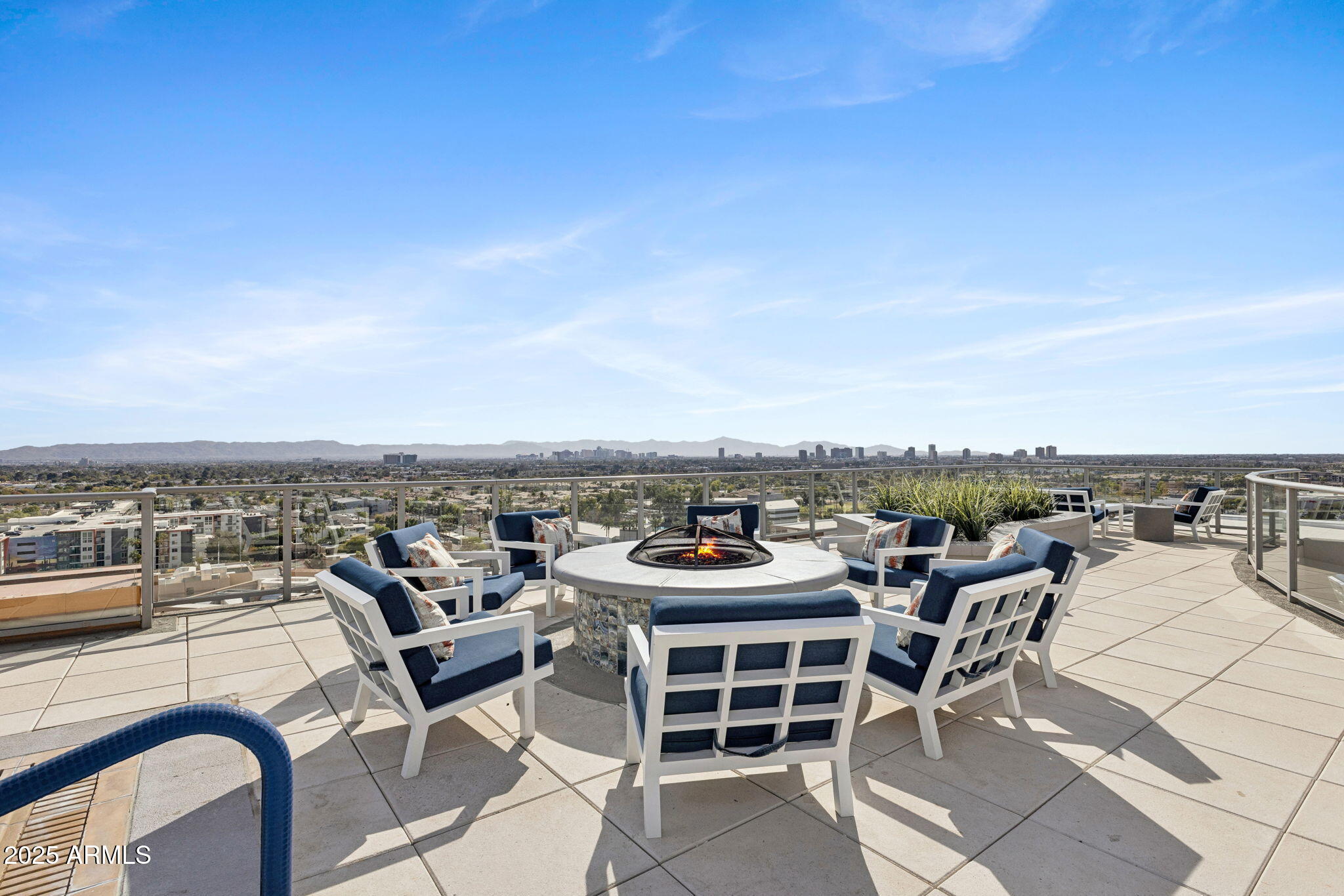 2211 East Camelback Road, Unit 601 Phoenix, AZ 85016 - Photo 37 of 61 a view of a terrace with furniture and a floor to ceiling window