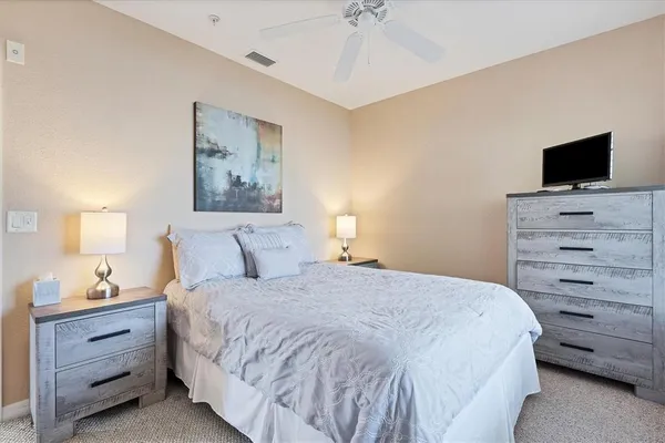 a bedroom with a bed and a television