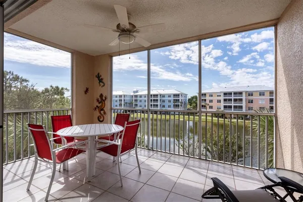 a dining room with furniture and a floor to ceiling window