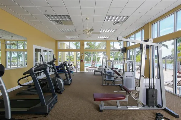 a view of a dining room with furniture large windows and wooden floor