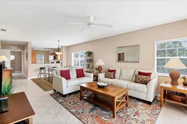 a living room with furniture a table and a window
