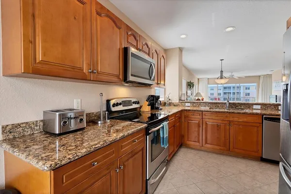 a kitchen with stainless steel appliances granite countertop a sink stove and cabinets