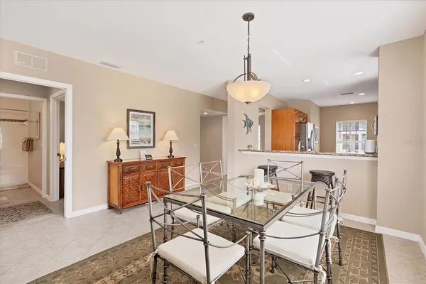 a view of a dining room with furniture and a chandelier
